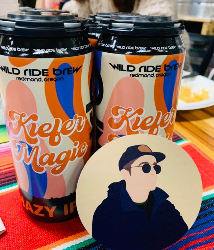 Wild Ride Brew Kiefer Magic beer cans with a coaster showing Kiefer's portrait