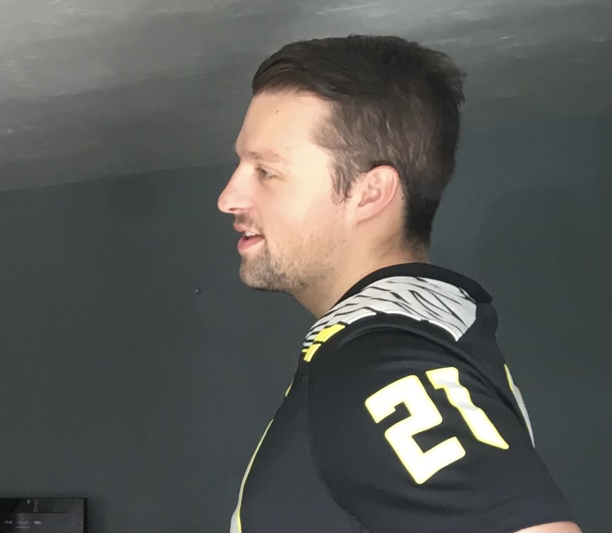 Kiefer in an Oregon Ducks jersey, smiling