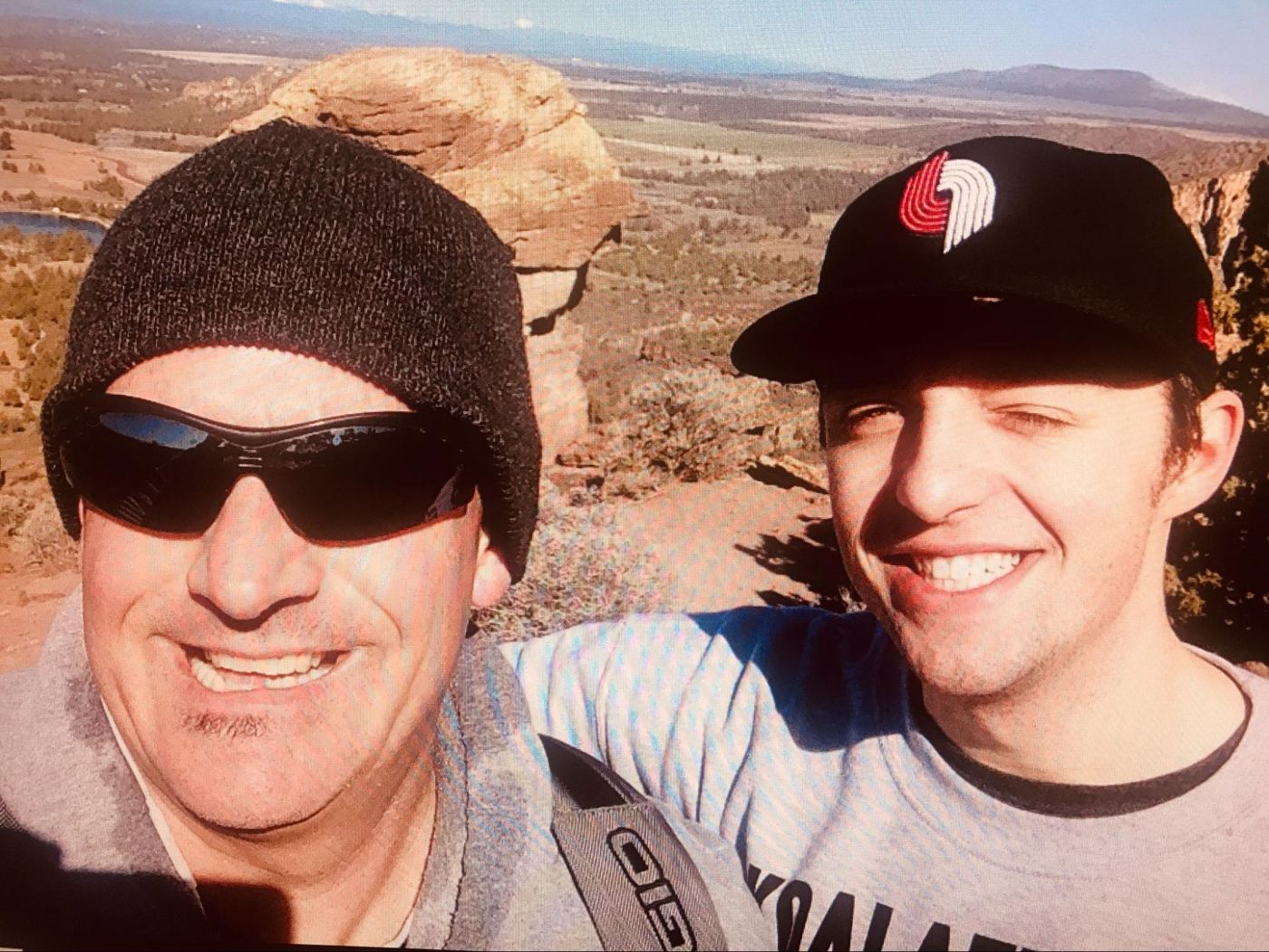 Kiefer and his dad smiling at a high-desert overlook